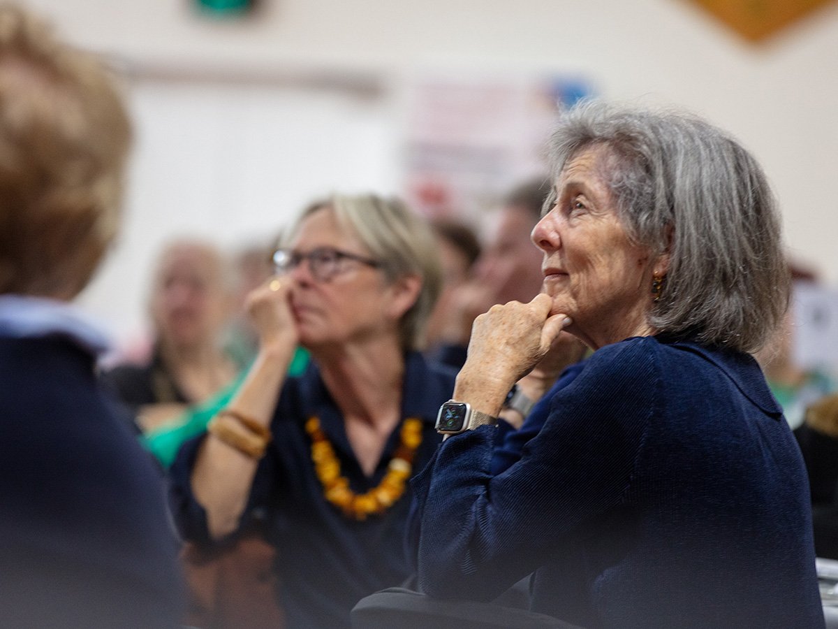 Ex-students listening intently to the presenter.