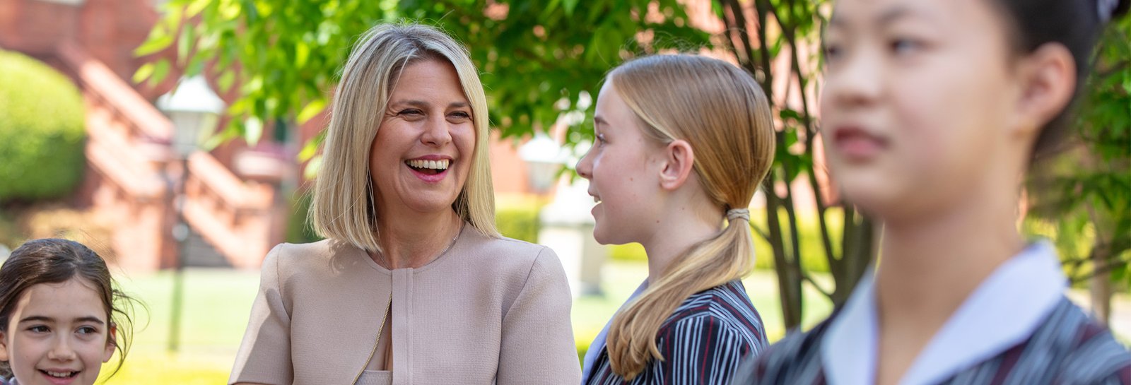 Principal smiling with students.