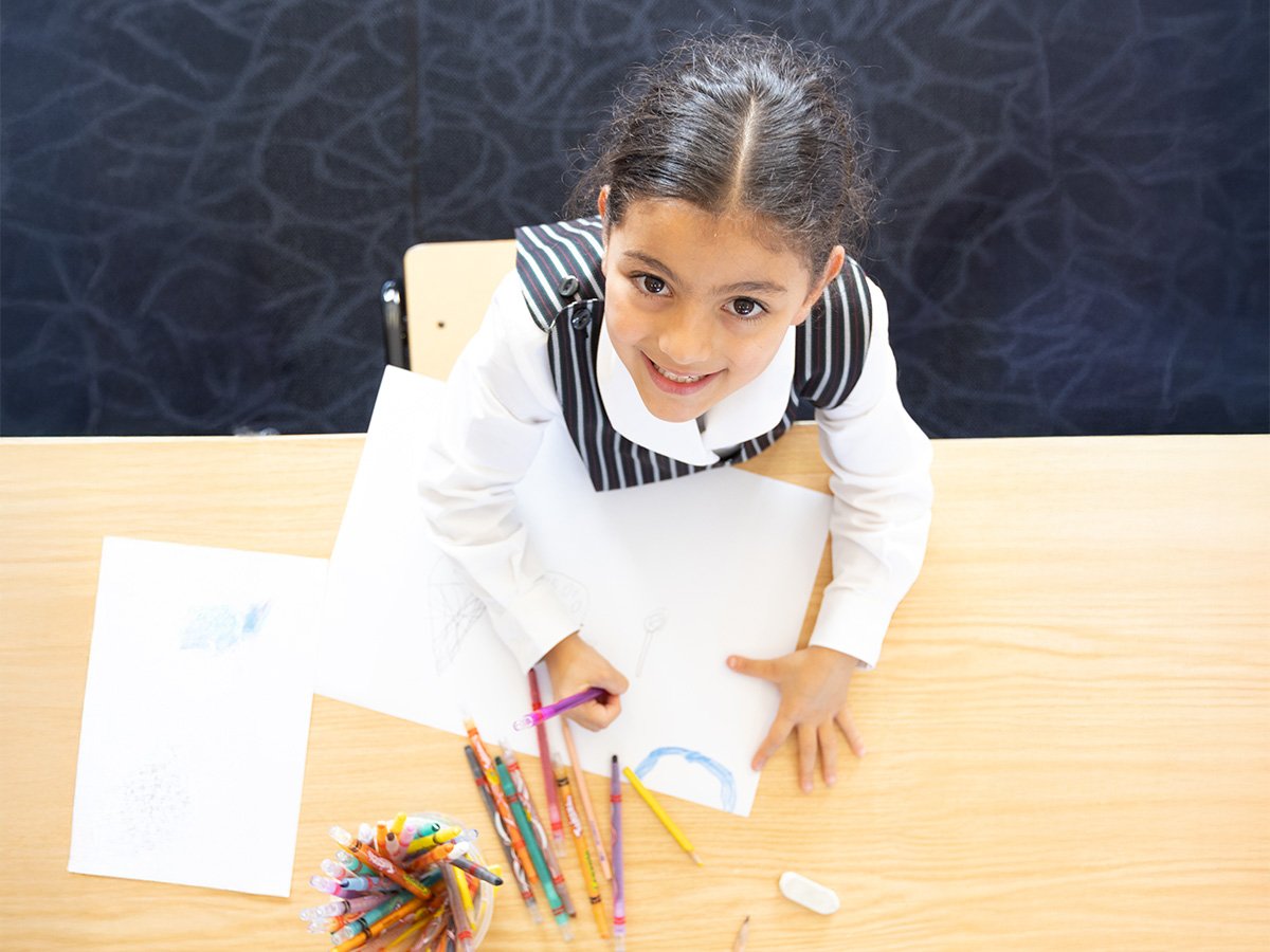 Junior school girl looking up at camera