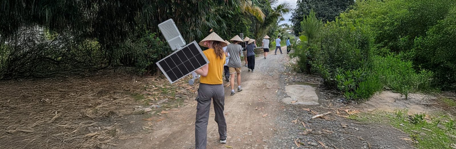 Students carrying a solar tower in Vietnam.