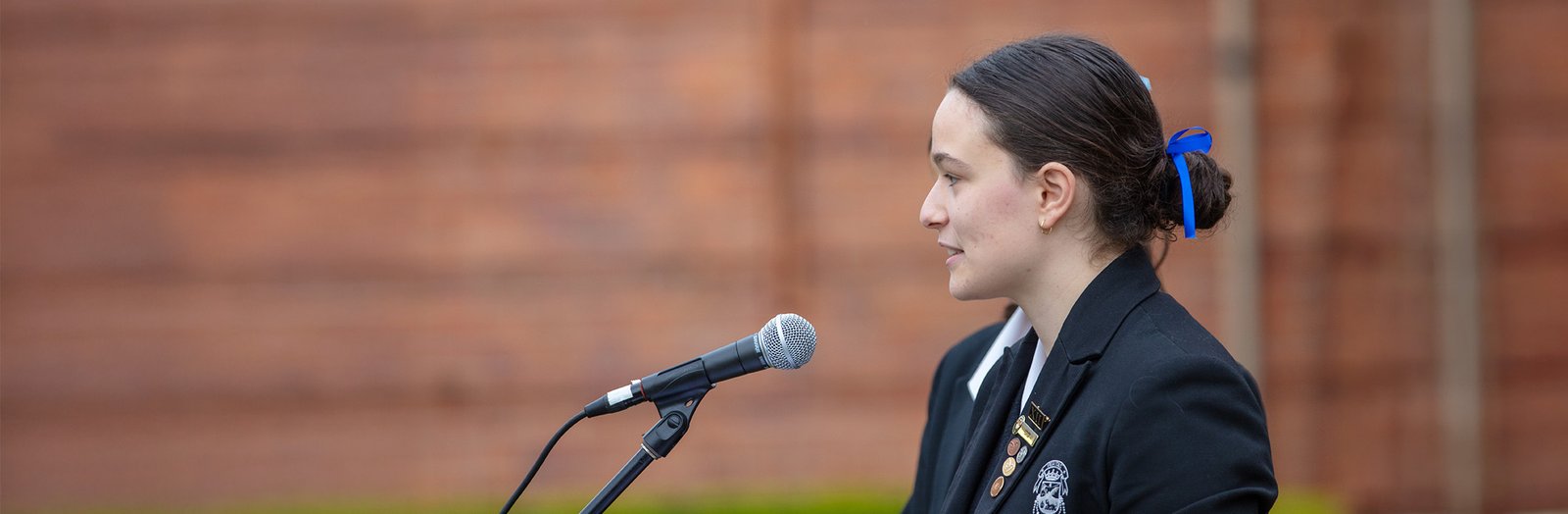 Senior student presenting a speech on stage.